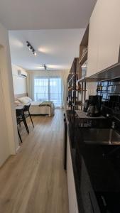 a kitchen and a living room with a table and a couch at Monoambiente Nuevo en Belgrano in Buenos Aires
