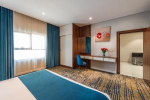 a hotel room with a bed and a desk at Al Qasr Corniche in Jazan +23 photos