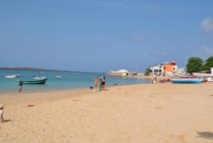 a group of people on a beach with boats in the water at Casa Tud Dret - By Bobbywashere in Sal Rei +112 photos