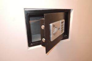 a microwave oven on a wall in a room at CityCorner Appartment in Szczecin