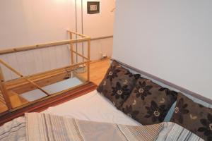 a bed with two pillows on it in a room at CityCorner Appartment in Szczecin