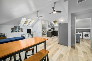 a kitchen and living room with a table and chairs at Cozy & Spacious Montrose Retreat with 3BR Near Houston Attractions in Houston
