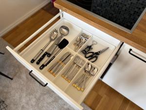 a drawer filled with utensils in a kitchen at Maslow apartments - Self check in in Vilnius