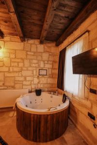 a large bath tub in a room with a window at akile ablanın evi in Ürgüp +70 photos