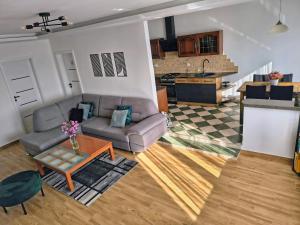 a living room with a couch and a table at Zakątek u Grzesia Gril & Chill in Trzebieszewo