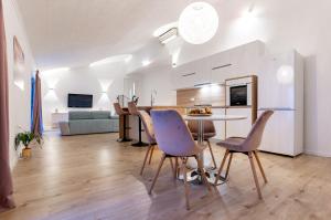a kitchen and living room with a table and chairs at Apartment Grguric Apartments in Palit