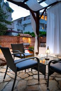 a group of chairs and a table on a patio at Apartment Grguric Apartments in Palit