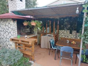 a patio with a table and chairs and a grill at Apartments Flower house in Bribir