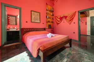 a red bedroom with a bed and a sink at Eleftherias Garden House in Afantou