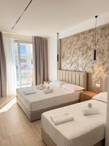 Postel nebo postele na pokoji v ubytování Moonlight Hotel