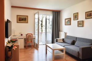 a living room with a couch and a table at Wilena Apartments in Villach