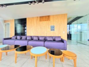 a living room with a purple couch and tables at Nice Studio in Palermo Soho in Buenos Aires
