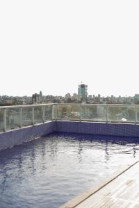 a pool of water with a city in the background at Nice Studio in Palermo Soho in Buenos Aires