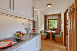 a kitchen with a sink and a counter top at Appartementhaus Kaltenbach-Stumm by PiaundDirk in Stumm