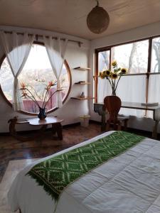 a bedroom with a bed and a large window at Casa del Artista in Valle de Bravo