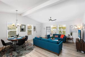 ein Wohnzimmer mit einem blauen Sofa und einem Tisch in der Unterkunft Disney Beaches Close Fire Pit Stadiums in Norwalk