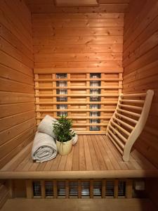 a sauna with a bench and a plant in it at Schwarzwald Ferienwohnung in Freudenstadt +20 photos