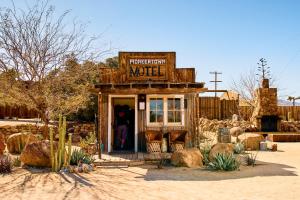 a small building with a sign that saysurrection motel at Pioneertown Motel in Pioneertown
