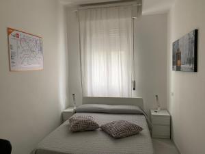 a bedroom with a bed with two pillows on it at Ripalta House in San Donato Milanese