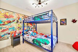 a bedroom with a blue bunk bed and a superhero mural at Near Disney - Spacious 3BR Condo with Pool in Orlando