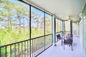 a screened porch with a view of the woods at Near Disney - Spacious 3BR Condo with Pool in Orlando