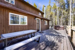a wooden deck with a bench on the side of a house at Mountain Cabin wHot Tub & Washer Dryer in Fairplay