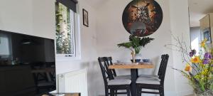 a dining room with a small table and chairs at De Bosuil in Putten