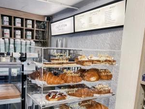 a bakery display case with many different types of pastries at Bourne Cottage, Cozy 3 Bed Haven, Sleeps 7, Pets Stay Free, Central Stay, Xbox Fun in Castleton