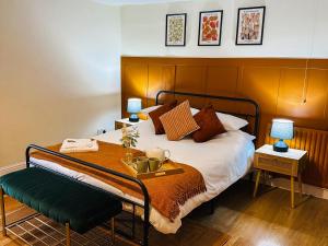 a bedroom with a bed with a tray on it at Bourne Cottage, Cozy 3 Bed Haven, Sleeps 7, Pets Stay Free, Central Stay, Xbox Fun in Castleton