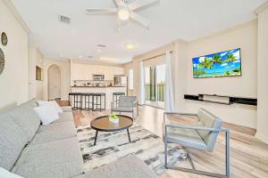 a living room with a couch and a table at Spacious 3BR Condo with Pool and Hot Tub, near Disney! in Orlando +21 photos
