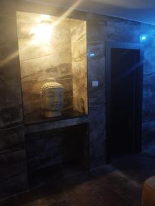 a statue in a room with a light at Shantel in Haifa