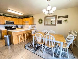 a kitchen and dining room with a table and chairs at Lake View Condo 930 2 in Garden City