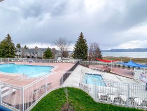 a swimming pool with a fence around it at Lake View Condo 930 2 in Garden City