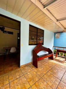 a room with a table and a bench on a tile floor at Cabinas Ole Caribe in Puerto Viejo