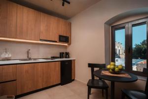 a kitchen with a table with a bowl of fruit on it at Villa il Borgο in Rhodes Town