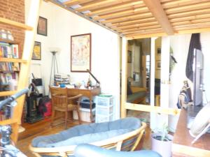 a living room with a blue couch and a desk at East Village Homestay in New York