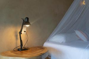 a lamp sitting on a table next to a bed at Cabanas Adobe Frente Al Mar in Puerto Escondido +119 photos