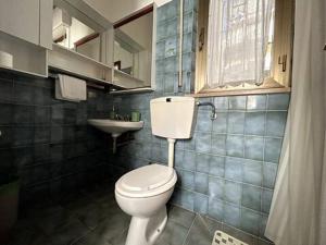 a bathroom with a toilet and a sink at ModernShore - Garden Hideaway in Alba Adriatica +12 photos