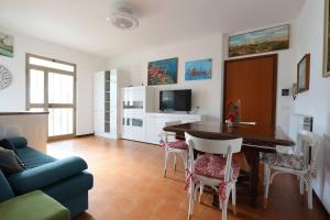 a living room with a table and a blue couch at ModernShore - Garden Hideaway in Alba Adriatica