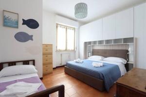 a bedroom with a bed and a desk in it at ModernShore - Garden Hideaway in Alba Adriatica