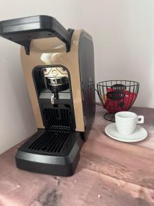 a coffee maker sitting on a table with a cup at Elba Apartment in Msida +5 photos