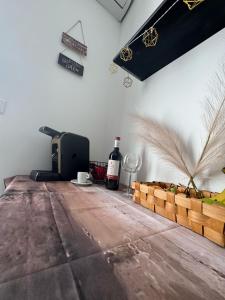 a room with a table with a bottle of wine at Elba Apartment in Msida