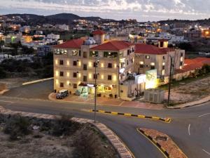 an aerial view of a building in a city at night at شقق دانة ليالينا المخدومه in Al Namas