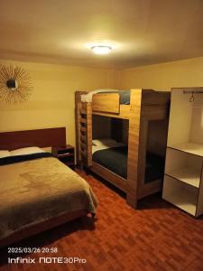 a bedroom with two bunk beds in a room at Hotel Guajacum Riobamba in Riobamba +11 photos