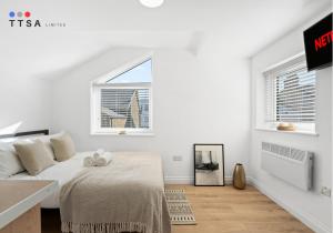 a white bedroom with a bed and a window at TTSA - Studio - Norwood Junction - B4 in Norwood