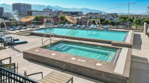 a swimming pool on top of a building at Convention Ctr Bespoke Beauty - 2BD Pool,Gym,Hot tub,Pkg in Salt Lake City