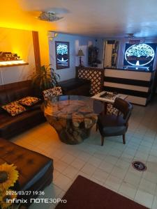 a living room with couches and a coffee table at Hotel Guajacum Riobamba in Riobamba
