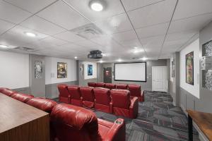 a waiting room with red leather chairs and a screen at Convention Ctr Bespoke Beauty - 2BD Pool,Gym,Hot tub,Pkg in Salt Lake City