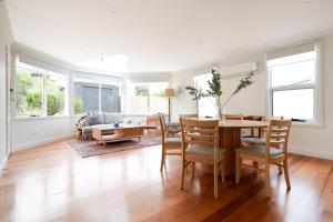 a living room with a table and chairs at Charming 3-Bedroom Home with Sunroom & Parking in Kings Park