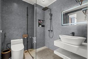a bathroom with a shower and a sink and a toilet at Lavender Hotel Vân Đồn in Tài Xá +46 photos